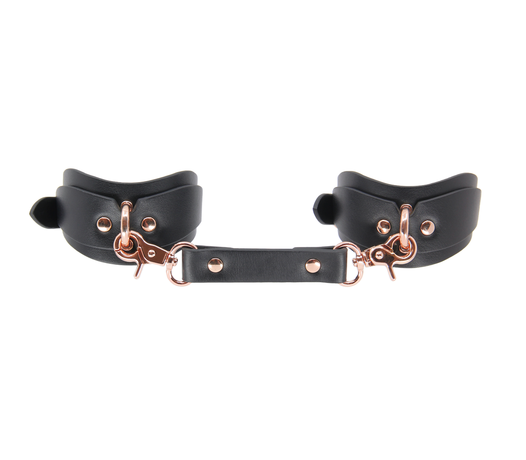 Shaped wrist cuffs with rose gold hardware - contoured leather restraints with premium finish