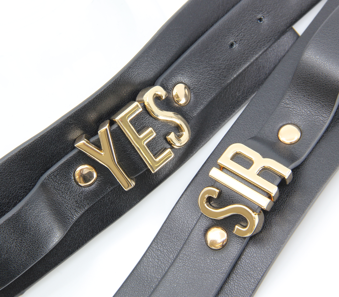 Yes Sir cuffs detail view - black leather fetish restraints with gold buckles and D-rings