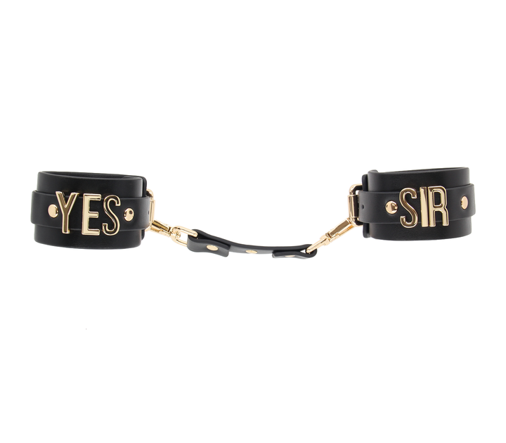 Love in Leather Yes Sir cuffs with gold hardware - premium leather BDSM wrist restraints with embossed text