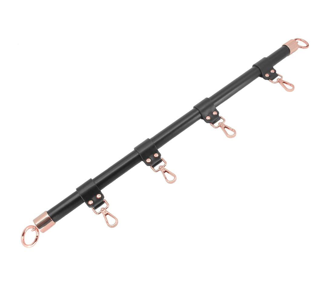 Black metal rod with rose gold hooks on a white background