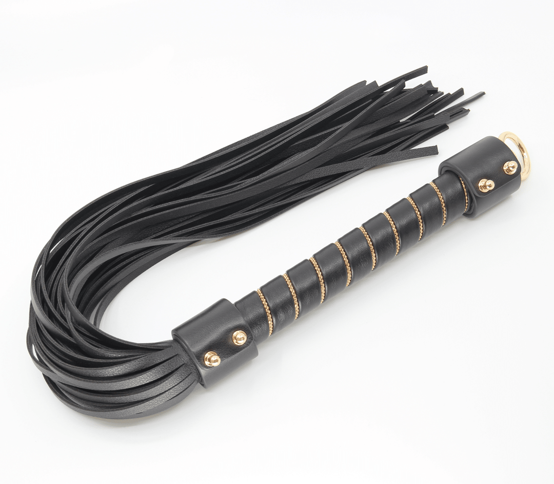 Chain handle flogger detail view - showing gold chain construction and leather tail attachment