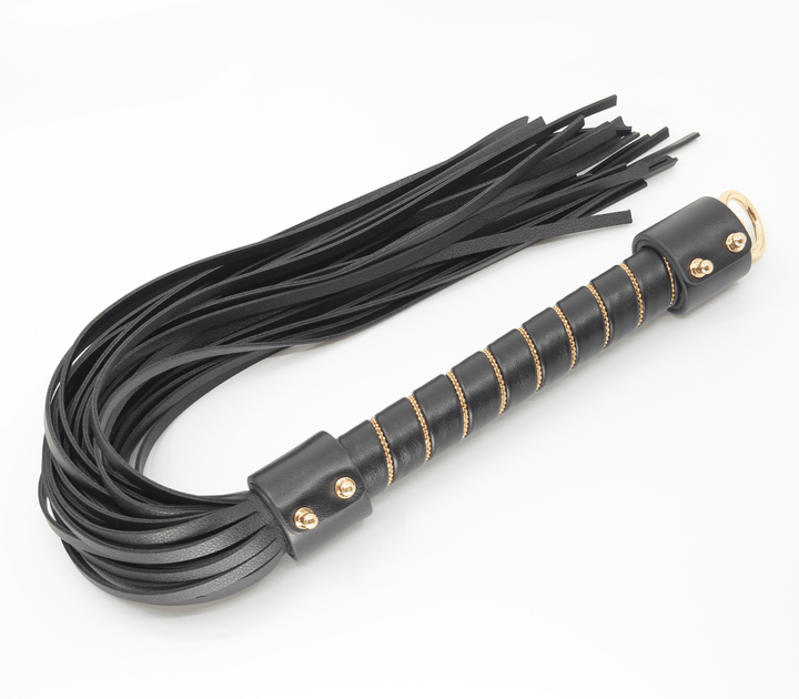 Chain handle flogger detail view - showing gold chain construction and leather tail attachment